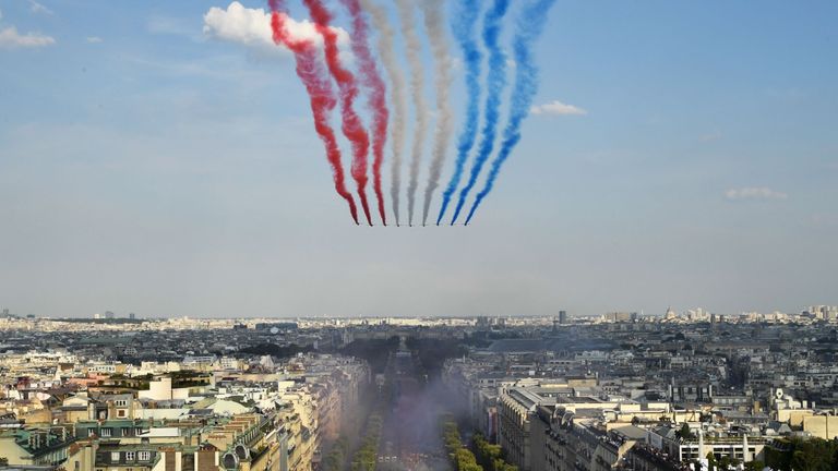 The Patrouille de France jets perform As supporters welcome France players for victory parade after they Russia 2018 World Cup final win