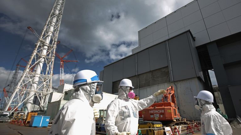 OKUMA, JAPAN - FEBRUARY 25: Workers stand outside reactor 4 as they continue the radiation decontamination process at the Tokyo Electric Power Co.'s embattled Fukushima Daiichi nuclear power plant on February 25, 2016 in Okuma, Japan. March 11, 2016 marks the fifth anniversary of the magnitude 9.0 earthquake and tsunami which claimed the lives of 15,894, and the subsequent damage to the reactors at TEPCO's Fukushima Daiichi Nuclear Power Plant causing the nuclear disaster which still forces 99,7