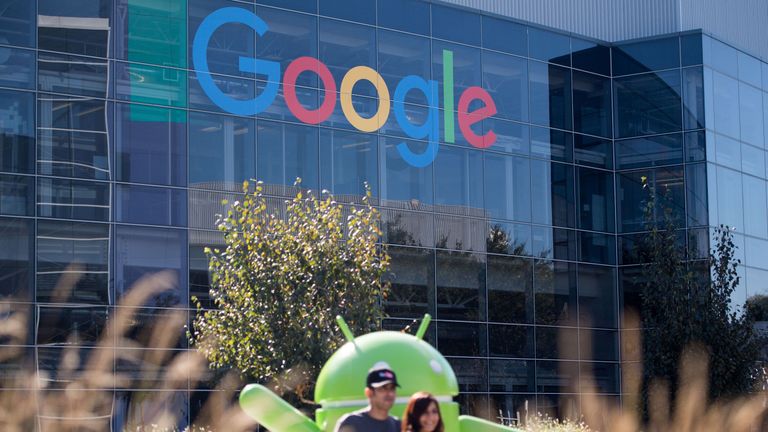 People pose for a picture near a Google sign and Android statue at the Googleplex in Menlo Park, California on November 4, 2016. / AFP PHOTO / JOSH EDELSON (Photo credit should read JOSH EDELSON/AFP/Getty Images)
