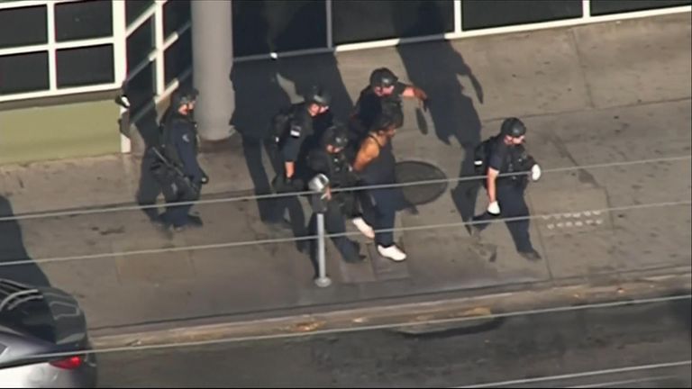 The suspect was led away in handcuffs after around three hours