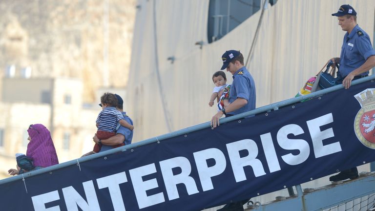 People disembark from HMS Enterprise in Malta following the 2014 Tripoli evacuation 