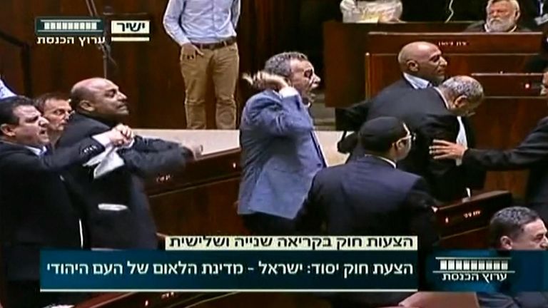 Politicians protest after controversial Israel law passes in parliament. 