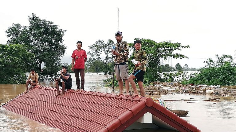 Villagers are stranded on a roof of a house after they evacuated floodwaters after the Xe Pian Xe Nam Noy dam collapsed 