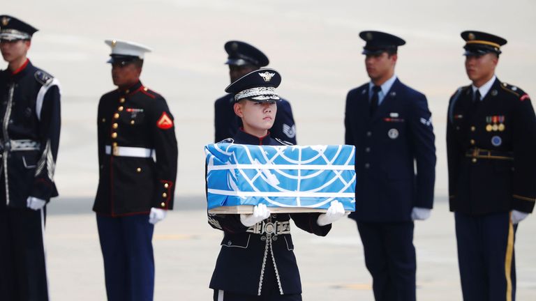 The remains were carried in boxes covered in blue United Nations flags