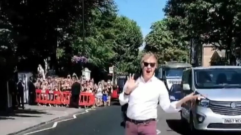 Sir Paul McCartney delights fans by appearing on the Abbey Road zebra crossing