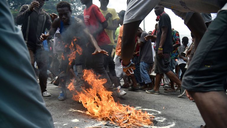 Demonstrators perform a voodoo ceremony during a march through the streets of Port-au-Prince