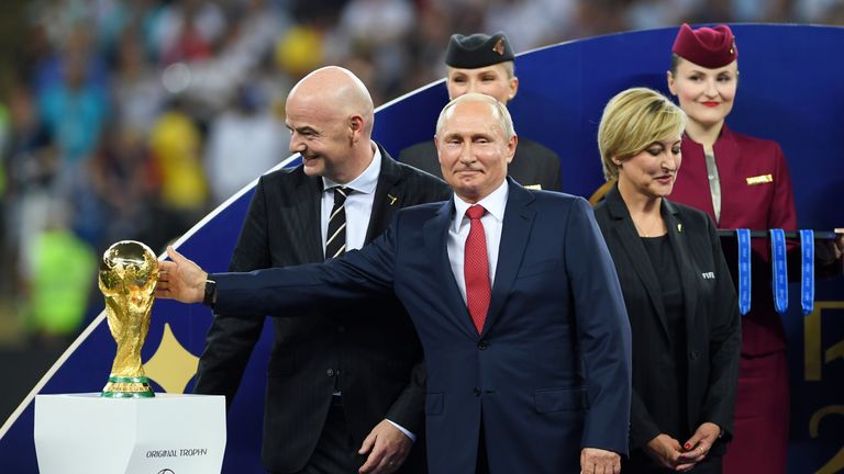 MOSCOW, RUSSIA - JULY 15: President of Russia Valdimir Putin touches the World Cup trophy as FIFA president Gianni Infantino looks on during the 2018 FIFA World Cup Final between France and Croatia at Luzhniki Stadium on July 15, 2018 in Moscow, Russia. (Photo by Shaun Botterill/Getty Images)
