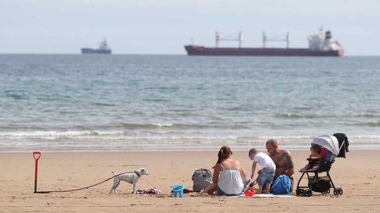 A family enjoy the weather on Tynemouth beach on North Tyneside