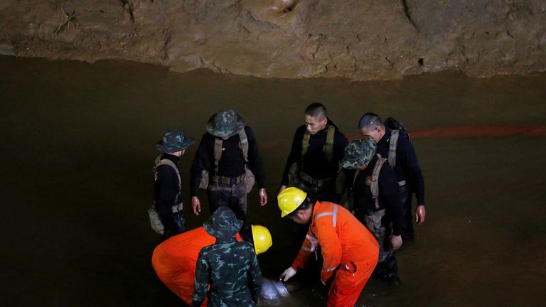 Soldiers and rescue workers work in Tham Luang cave complex, as an ongoing search continues