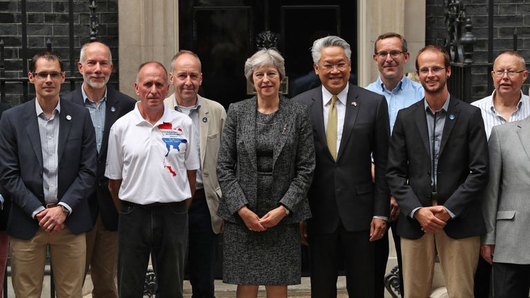Prime Minister Theresa May (centre) with the Thai Ambassador Pisanu Suvanajata (centre right) in Downing Street, London with the divers and support team from the British Cave Rescue Council who joined the rescue of the 12 schoolboys and their football coach from a flooded cave in Thailand. PRESS ASSOCIATION Photo. Picture date: Tuesday July 24, 2018. Photo credit should read: Jonathan Brady/PA Wire