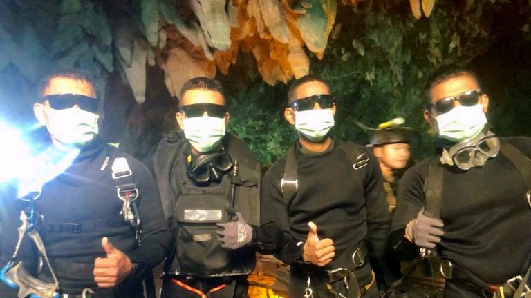 Four Thai navy SEALs give a thumbs up as they leave the cave