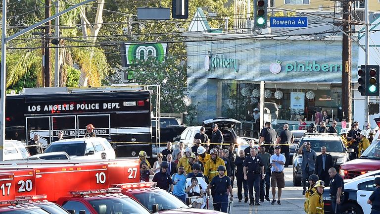 A woman on a stretcher was led away by emergency services