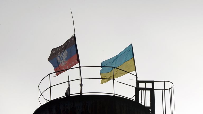 Flags of Ukraine (R) and of the self-proclaimed People&#39;s Republic of Donetsk fly on a water tower in the city of Krasny Partizan near Donetsk on December 13, 2014. Russia responded angrily on December 13 to news that US senators had passed a bill calling for fresh sanctions against Moscow and the supply of lethal military aid to Ukraine. AFP PHOTO / VASILY MAXIMOV (Photo credit should read VASILY MAXIMOV/AFP/Getty Images)
