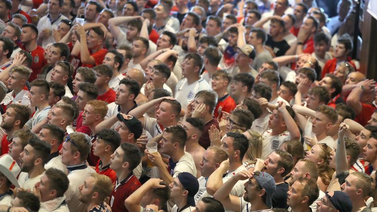 England fans watch England take on Sweden in the World Cup quarter finals at Ashton Gate World Cup fans village at the Bristol City football club on July 7, 2018 in London
