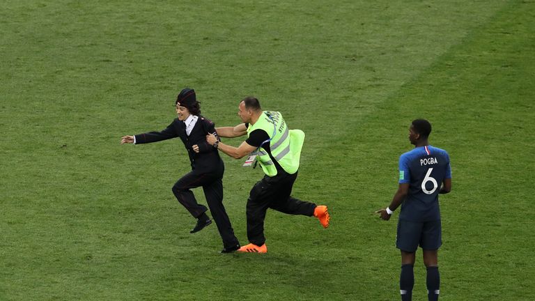 MOSCOW, RUSSIA - JULY 15: Stewards drag a pitch invader off the pitch during the 2018 FIFA World Cup Final between France and Croatia at Luzhniki Stadium on July 15, 2018 in Moscow, Russia. (Photo by Kevin C. Cox/Getty Images)
