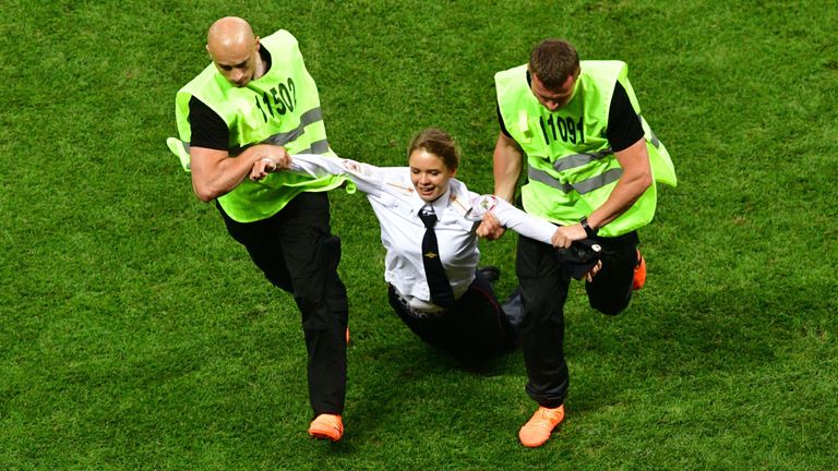 Stewards remove a pitch invader during the Russia 2018 World Cup final football match between France and Croatia at the Luzhniki Stadium in Moscow on July 15, 2018. (Photo by Mladen ANTONOV / AFP) / RESTRICTED TO EDITORIAL USE - NO MOBILE PUSH ALERTS/DOWNLOADS (Photo credit should read MLADEN ANTONOV/AFP/Getty Images)
