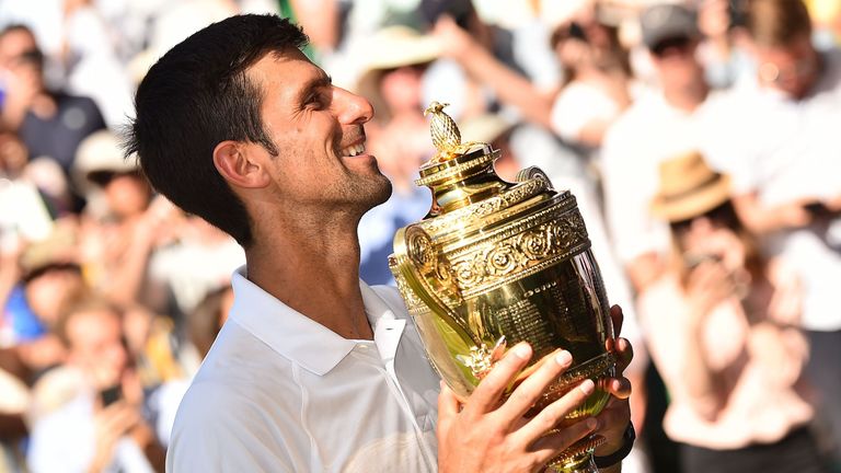 Serbia&#39;s Novak Djokovic poses with the winners trophy after beating South Africa&#39;s Kevin Anderson 6-2, 6-2, 7-6 in their men&#39;s singles final match on the thirteenth day of the 2018 Wimbledon Championships at The All England Lawn Tennis Club in Wimbledon, southwest London, on July 15, 2018