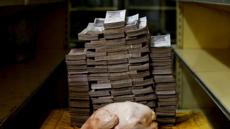 A 2.4 kg chicken is pictured next to 14,600,000 bolivars, its price and the equivalent of 2.22 USD, at a mini-market in Caracas, Venezuela