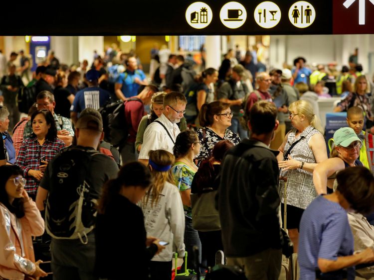 Air Alaska passengers wait in the terminal following an incident where an airline employee took off in an airplane, at Seattle-Tacoma International Airport in Seattle, Washington, U.S., August 10, 2018
