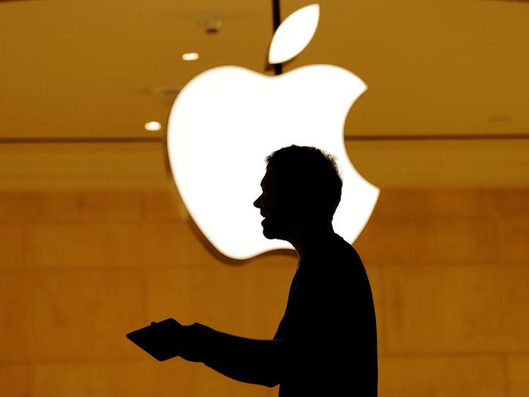 Customers walk past an Apple logo inside of an Apple store at Grand Central Station in New York