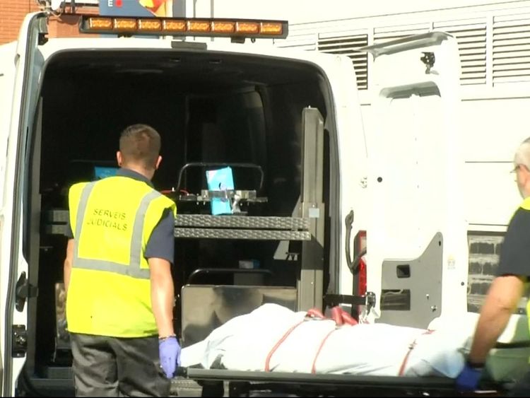 The suspect is wheeled onto an ambulance