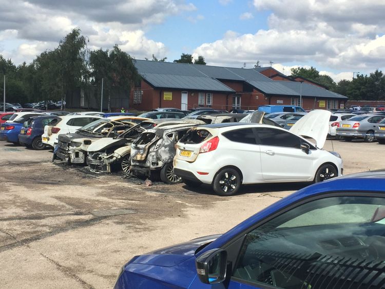 Burned out vehicles in the car park of Birmingham prison