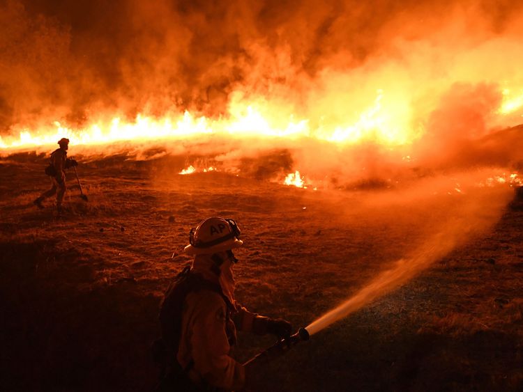Firefighters conduct a controlled burn to defend houses against flames from the Ranch fire, as it continues to spreads towards the town of Upper Lake, California on August 2, 2018. - Thousands of firefighters in California made some progress against several large-scale blazes that have turned around 200,000 acres (80,940 hectares) into an ashen wasteland, destroyed expensive homes, and killed eight fire personnel and civilians in the most populous US state. (Photo by Mark RALSTON / AFP) (Photo c