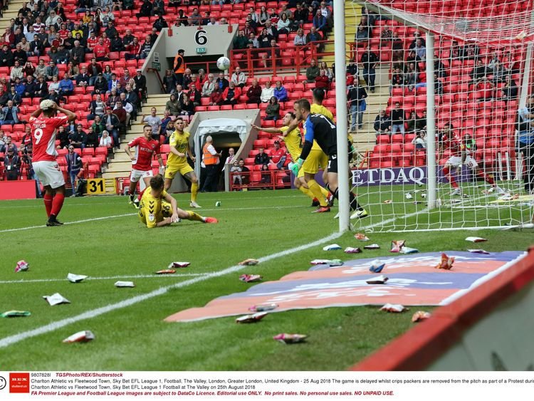 The game is delayed whilst crips packers are removed from the pitch as part of a Protest during Charlton Athletic vs Fleetwood Town Sky Bet EFL League 1 Football at The Valley on 25th August 2018