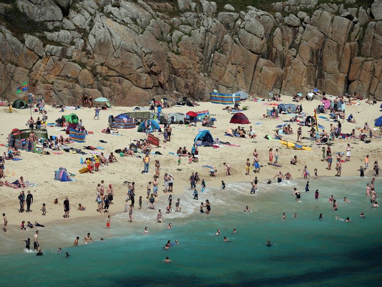 Holidaymakers enjoy the beach at Porthcurno, near Penzance 