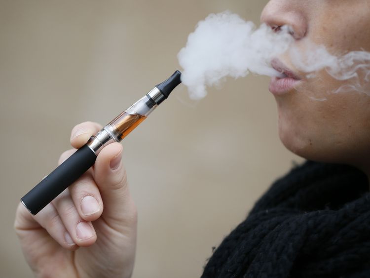 MIAMI, FL - APRIL 24: Julia Boyle enjoys an electronic cigarette as she waits for customers at the Vapor Shark store on April 24, 2014 in Miami, Florida. Brandon Leidel, CEO, Director of Operations Vapor Shark, said he welcomes the annoucement by the Food and Drug Administration that they are proposing the first federal regulations on electronic cigarettes, which would ban sales of the popular devices to anyone under 18 and require makers to gain FDA approval for their products. (Photo by Joe Ra