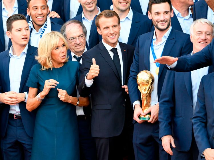 Hugo Lloris holds the World Cup next to President Macron