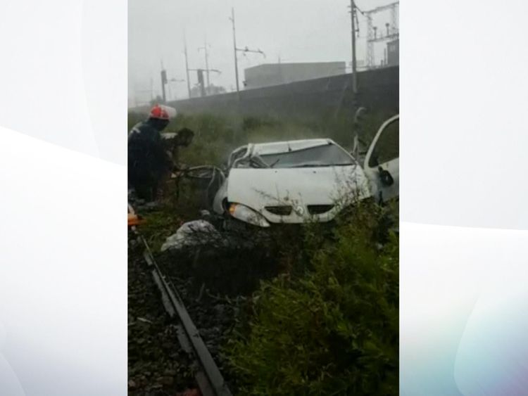 A car lies wrecked after the bridge collapsed