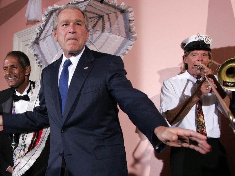 US President George W. Bush (C) dances with the Burnell Brunious (L), grand marshal of the Euphonious brass dixie band, during a United States Chamber of Commerce Reception at Gallier Hall in New Orleans, Louisiana, on April 21, 2008. AFP PHOTO/SAUL LOEB (Photo credit should read SAUL LOEB/AFP/Getty Images) 