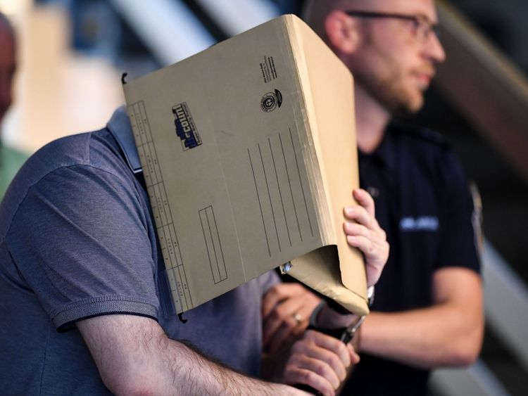 
The Spanish defendant covers his face as he arrives in the courtroom in Freiburg, southern Germany, on August 6, 2018. - A German court jailed the Spanish man for 10 years for repeatedly sexually abusing a young boy whose mother and stepfather sold him to paedophiles online. (Photo by Patrick Seeger / dpa / AFP) / Germany OUT (Photo credit should read PATRICK SEEGER/AFP/Getty Images)