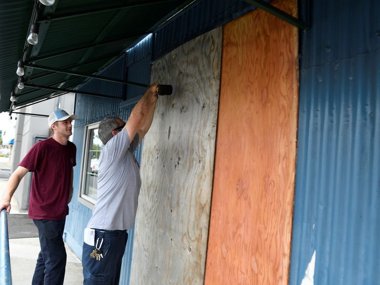 Geoffrey Seidman, owner of Honolulu Beerworks, boards up his brewery as Hurricane Lane approaches Honolulu, Hawaii, U.S. August 23, 2018. REUTERS/Hugh Gentry