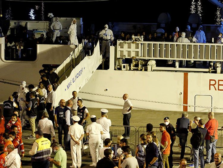 Police photographed the migrants for ID checks when they disembarked the ship