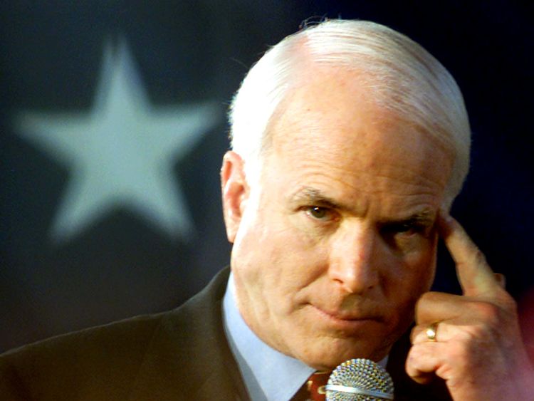 Republican presidential hopeful John McCain points to his head during his Carolina kickoff rally at Presbyterian College February 2, 2000