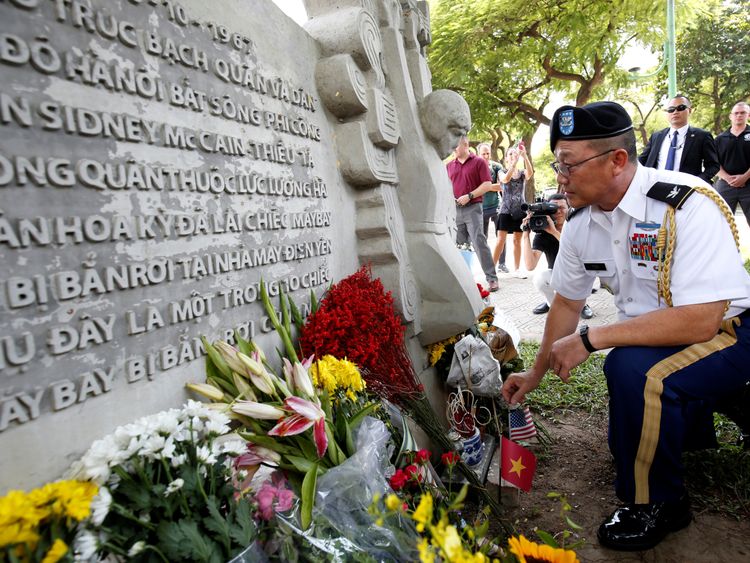 Military Attache Ton Tuan from US Embassy places incense at the McCain Memorial in Hanoi.