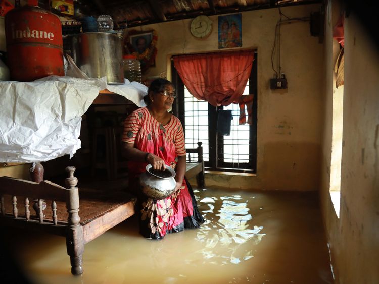 A woman sits inside her house in the Ernakulam district of Kochi