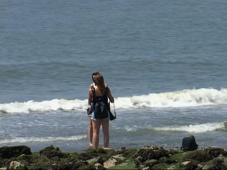 Two women paddle to cool off in the soaring temperatures