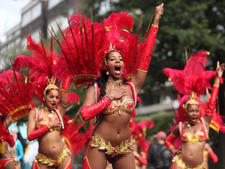 Performers in costume take part in the carnival on the main Parade day of the Notting Hill Carnival in west London on August 27, 2018. - Nearly one million people are expected by the organizers Sunday and Monday in the streets of west London's Notting Hill to celebrate Caribbean culture at a carnival considered the largest street demonstration in Europe. (Photo by Daniel LEAL-OLIVAS / AFP) (Photo credit should read DANIEL LEAL-OLIVAS/AFP/Getty Images) 