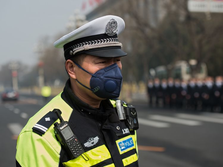 A police officer Beijing protects wears a mask to avoid breathing in polluted air