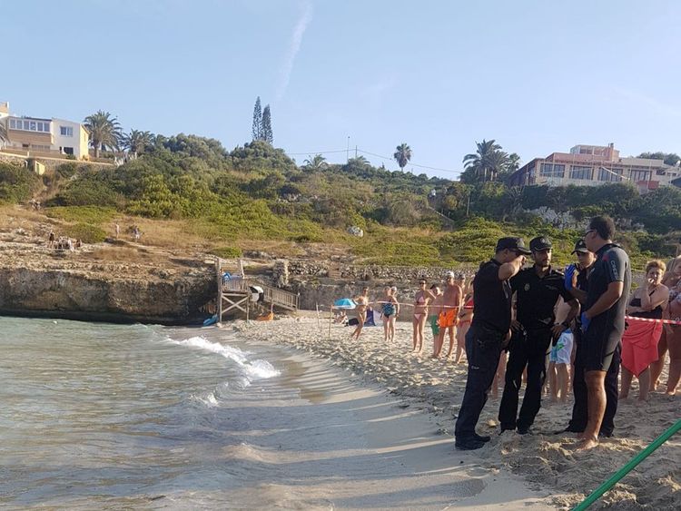 Police evacuated the beach as they tried to guide the shark back out to sea before hauling it onto the beach. Pic: Salvament AquÃ tic Illes Balears
