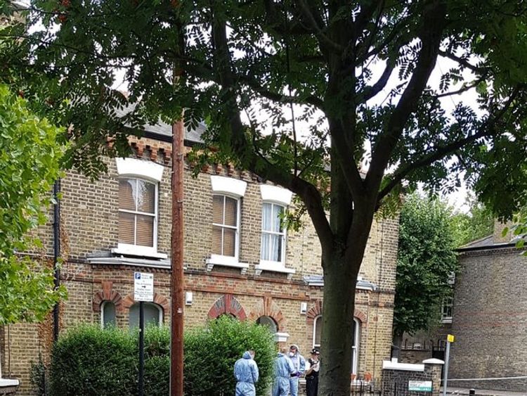 Forensics officers outside the address in Battersea. Pic: Miguel Sobriera