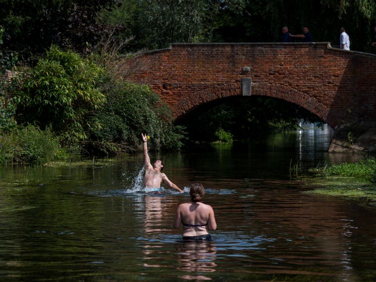 A couple play catch in the River Stour in Fordwich, Kent, as a second heatwave continues in the UK