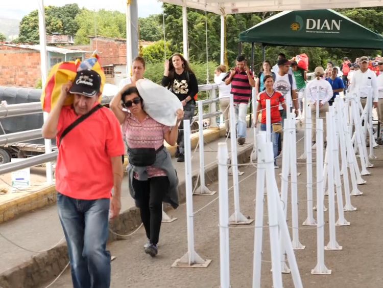 Thousands of people have been streaming across the bridge between Venezuela and Colombia