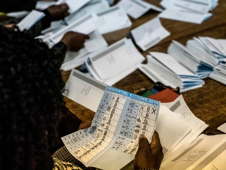 Election officials tally presidential candidates&#39; ballots during counting