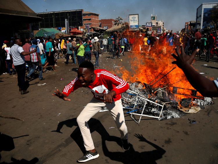 Supporters of the opposition Movement for Democratic Change party (MDC) of Nelson Chamisa block a street in Harare, Zimbabwe