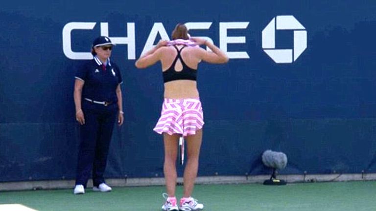 Alize Cornet turns away from court to readjust her top. Pic: ESPN