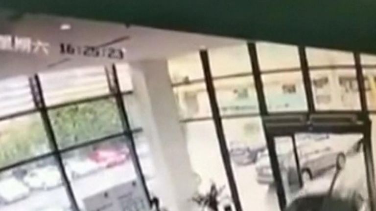 A woman in China mistakes the accelerator for the brakes in a car showroom